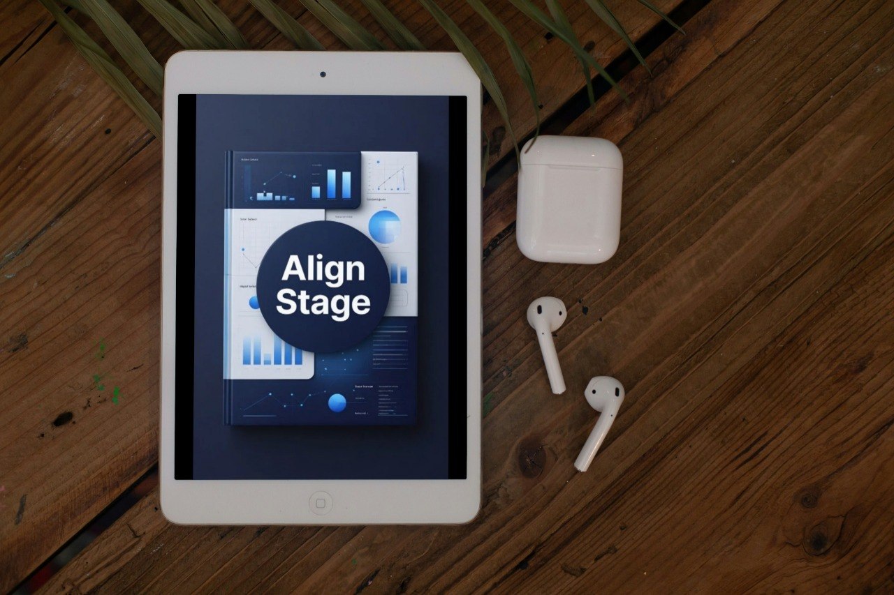 Tablet displaying a 'Align Stage' app on a wooden surface with AirPods.