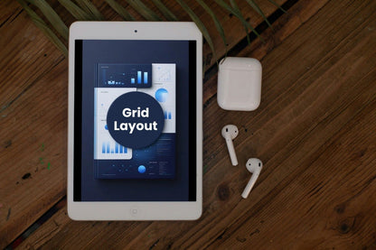 Tablet displaying a grid layout on a wooden surface with AirPods.