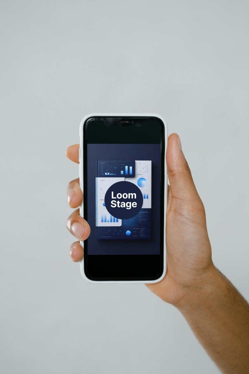 Hand holding a smartphone with an app interface on a plain background