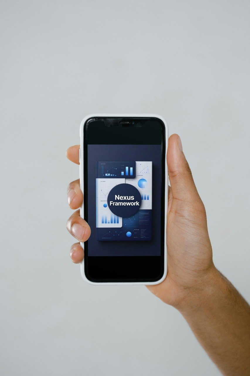 Hand holding a smartphone with an app interface on a plain background