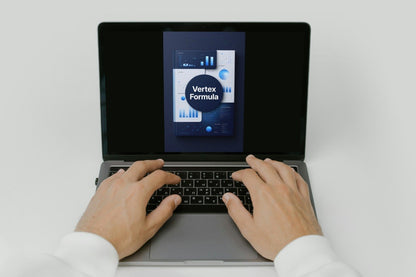 Person using a laptop with a screen displaying 'courses' on a white background